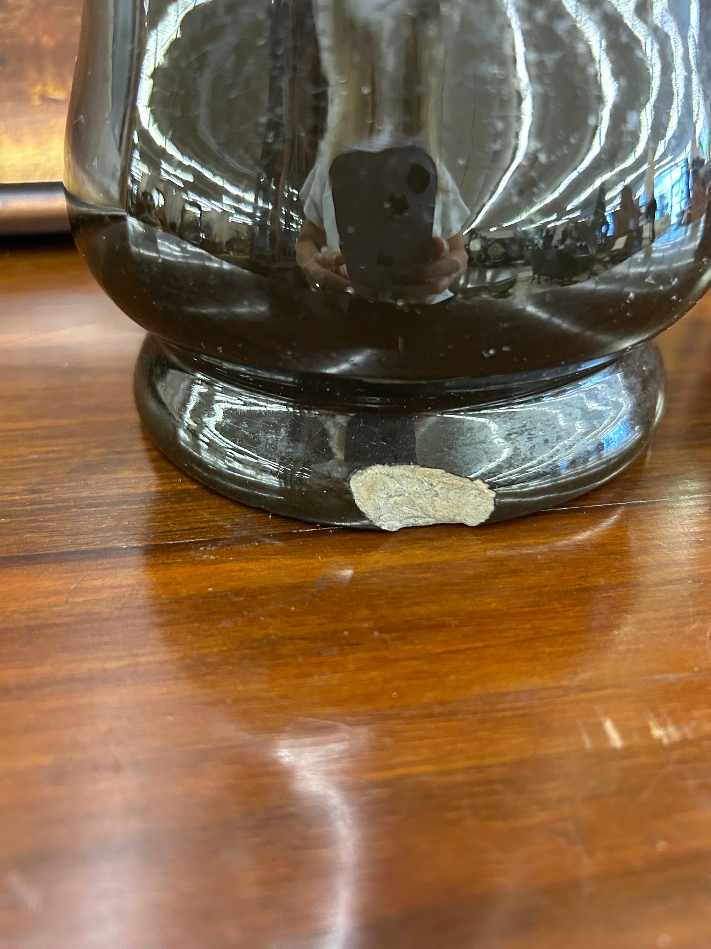 Art pottery vase with a rich dark glaze and raised floral detail (small chip at base)